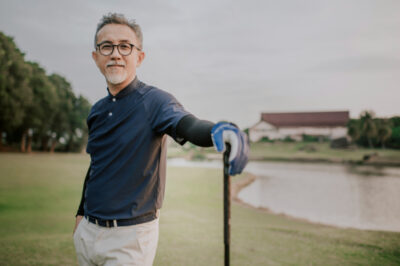 An asian chinese active senior man golfer